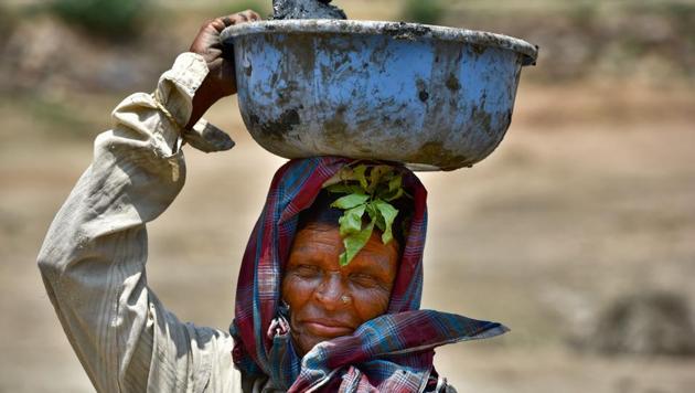 Women work for the lake rejuvenation project under MNREGA scheme at Bevanahalli village of Mandia district in Karnataka. A third consecutive year of drought has led to precariously low levels of water in reservoirs across the state, with the government announcing that it will only be able to provide water for drinking purposes. (Arijit Sen/HT Photo)