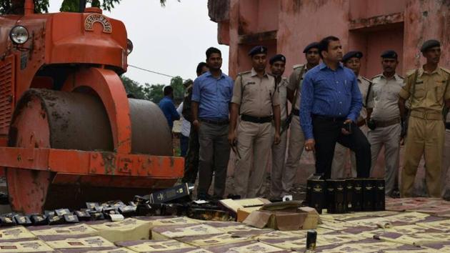 Seized liquor bottles being destroyed  in Patna. (AP Dube/HTfile photo)