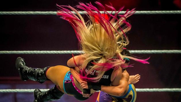 Alexa Bliss (L) and Bayley battle in the ring during the WWE show at Zenith Arena in Lille, France. (PHILIPPE HUGUEN / AFP)