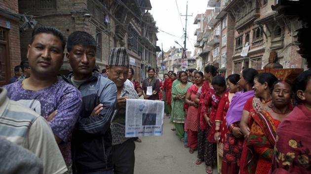 Nepalese stand in a queue to cast their votes at a polling station during the local election in Bhaktapur, Nepal, on Sunday.(AP)