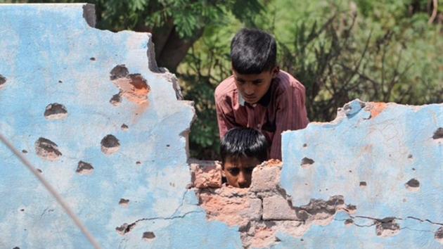 Children inspect a house damaged by mortar shells at Jhanghar village in Nowshera. (Nitin Kanotra/HT Photo) Children inspect a house damaged by mortar shells at Jhanghar village in Nowshera. (Nitin Kanotra/HT Photo)