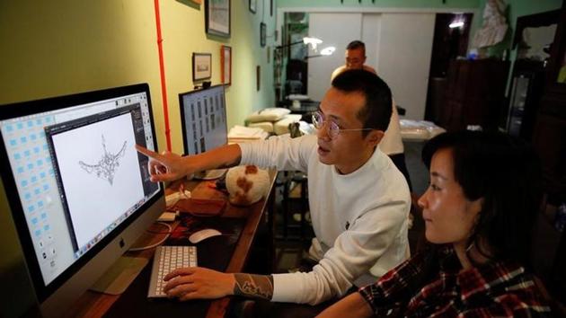 Eason Zhou, 28, mother of a 5-year-old child, checks a tattoo design on a computer with her tattoo artist Shi Hailei at Samurai Tattoo in Shanghai, China. Zhou underwent a caesarean delivery (C-section) because the baby was past its due date. She has tried a scar-removal product before but it didn't work very well. She saw reports on the artist and wanted to have a try. ‘In the past people thought tattoos were just for men, but now women are starting to get them too,’ she said. (Aly Song / Reuters) Eason Zhou, 28, mother of a 5-year-old child, checks a tattoo design on a computer with her tattoo artist Shi Hailei at Samurai Tattoo in Shanghai, China. Zhou underwent a caesarean delivery (C-section) because the baby was past its due date. She has tried a scar-removal product before but it didn't work very well. She saw reports on the artist and wanted to have a try. ‘In the past people thought tattoos were just for men, but now women are starting to get them too,’ she said. (Aly Song / Reuters)
