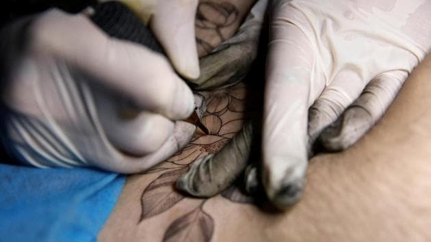 A tattoo of a flower is applied to Kiki's belly. ‘This is my fifth tattoo. I like flowers and have tattoos of flowers on my shoulders and legs. I enjoy getting tattoos, it's addictive,’ Kiki said. She chose to have caesarean delivery (C-section) over natural birth because she didn't want to suffer too much. (Aly Song / Reuters) A tattoo of a flower is applied to Kiki's belly. ‘This is my fifth tattoo. I like flowers and have tattoos of flowers on my shoulders and legs. I enjoy getting tattoos, it's addictive,’ Kiki said. She chose to have caesarean delivery (C-section) over natural birth because she didn't want to suffer too much. (Aly Song / Reuters)