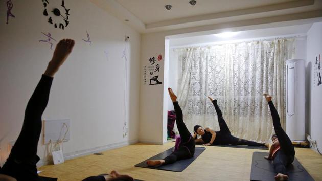 Wang Ruoyu, 37, a mother of a 16-year-old son and a yoga coach, teaches a yoga class. (Aly Song / Reuters) Wang Ruoyu, 37, a mother of a 16-year-old son and a yoga coach, teaches a yoga class. (Aly Song / Reuters)