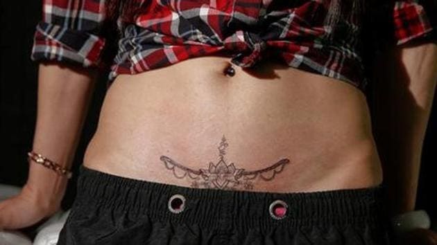 Eason Zhou, poses with her new tattoo at Samurai Tattoo. (Aly Song / Reuters) Eason Zhou, poses with her new tattoo at Samurai Tattoo. (Aly Song / Reuters)