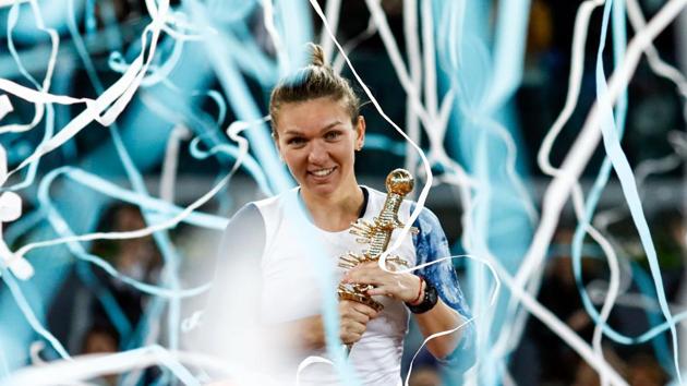 Romanian tennis player Simona Halep celebrates with her WTA Madrid Open trophy after her victory over French tennis player Kristina Mladenovic in the final in on Saturday.(AFP)