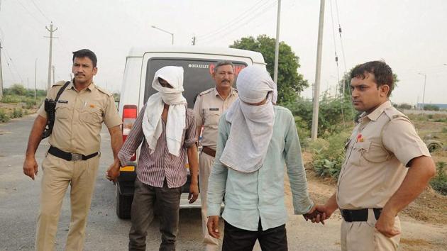 Police take the accused to the scene of the crime where they allegedly dumped a woman’s body after raping her in Rohtak.(PTI Photo)