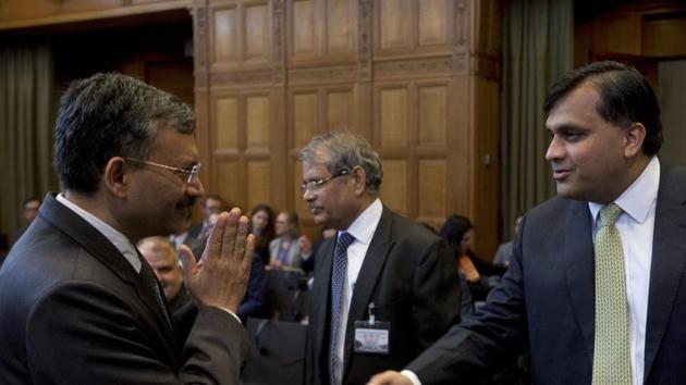 Dr Deepak Mittal, joint secretary of India's external affairs ministry, greets Pakistan's Syed Faraz Hussain Zaidi before the court proceedings begin at The Hague, Netherlands, on May 15, 2017. (AP) Dr Deepak Mittal, joint secretary of India's external affairs ministry, greets Pakistan's Syed Faraz Hussain Zaidi before the court proceedings begin at The Hague, Netherlands, on May 15, 2017. (AP)