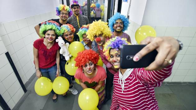 Sheetal (C) and her group of volunteers pose for a selfie with everyone dressed as clowns. The group follows a policy of no physical contact with the children or indulging themselves in any selfies during their performance. (Raj K Raj/HT Photo)