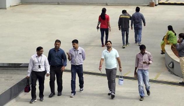 Wipro Ltd. employees walk inside the company's compound at their headquarters in Bangalore.(AP)