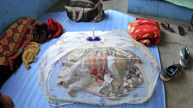 A child sleeps at a relief camp set up at a government school in Nowshera. A child sleeps at a relief camp set up at a government school in Nowshera.