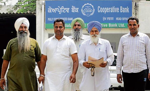 Farmers coming out of the Central Cooperative Bank in Patiala on Monday. (Bharat Bhushan/HT) Farmers coming out of the Central Cooperative Bank in Patiala on Monday. (Bharat Bhushan/HT)