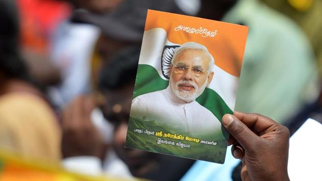 Prime Minister Narendra Modi wave flags and posters at a public rally. (AFP File Photo) Prime Minister Narendra Modi wave flags and posters at a public rally. (AFP File Photo)