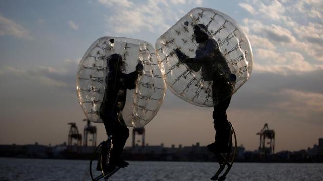 Ryoichi Ando (R), 27, a virtual-reality researcher and an inventor of ‘Bubble Jumper’, competes with his opponent as they demonstrate the sport. Ando said he felt as if he were wearing the kind of augmented body suit found in science-fiction movies that boosts the wearer's strength. In ‘Bubble Jumper’, players walking on stilts and wearing inflatable bubble protectors crash into each other like sumo wrestlers. (Kim Kyung-Hoon / Reuters)