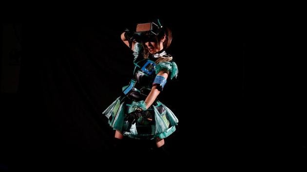 Piyohina, an Internet idol and singer of animation songs, poses wearing a head-mount display and an armband sensor for playing ‘HADO’ in Tokyo, Japan. In ‘HADO’, players in head-mounted augmented-reality displays and armband sensors dodge waves of light as they fire energy balls at each other in a virtual arena. ‘When I play HADO, I always simulate in my head the best way to fire an energy ball,’Piyohina said. (Kim Kyung-Hoon / Reuters)