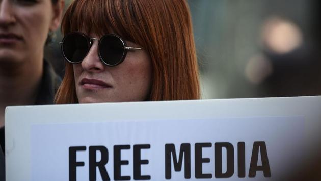 A journalist holds a placard reading "free media" during a demonstration for the World Press Freedom Day in Istanbul, May 3. In Turkey, the constitution has been changed by a wafer thin margin and Recep Erdogan is set to be remake his country in his image, while the jails fill with purged bureaucrats, soldiers, journalists and cartoonists.