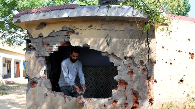 A man inspects the walls of a school damaged by Pakistan’s shelling at Jhanghar village. (Nitin Kanotra/HT Photo) A man inspects the walls of a school damaged by Pakistan’s shelling at Jhanghar village. (Nitin Kanotra/HT Photo)