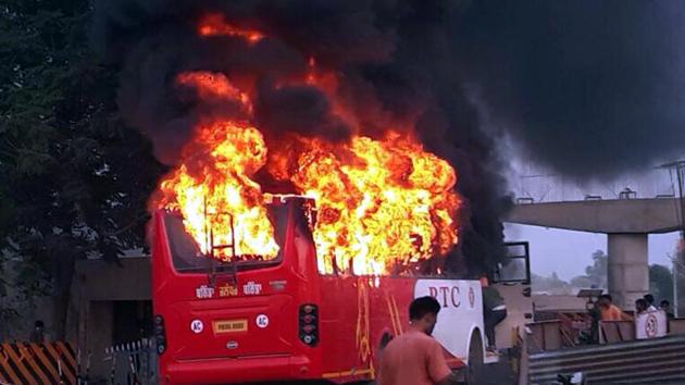 The bus on fire near the railway crossing in Rampura Phul near Bathinda on Saturday, May 13.(HT File Photo)
