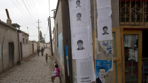 In this July 2014 file photo, wanted posters of men involved in terror attacks are posted on a street of Aksu in western China's Xinjiang province. Human Rights Watch said on May 16, 2017 that China appears to be laying the groundwork for the mass collection of DNA samples from residents in the restive region with a large Muslim population. (AP) In this July 2014 file photo, wanted posters of men involved in terror attacks are posted on a street of Aksu in western China's Xinjiang province. Human Rights Watch said on May 16, 2017 that China appears to be laying the groundwork for the mass collection of DNA samples from residents in the restive region with a large Muslim population. (AP)