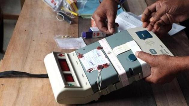 Election Commission officials seal an Electronic Voting Machine (EVM) prior to the start of voting at a polling station. (AFP File Photo) Election Commission officials seal an Electronic Voting Machine (EVM) prior to the start of voting at a polling station. (AFP File Photo)