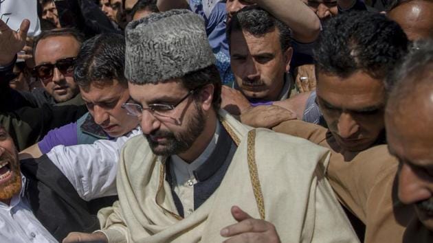 All Parties Hurriyat Conference Chairman Mirwaiz Umar Farooq, stands with supporters during a protest in Srinagar.