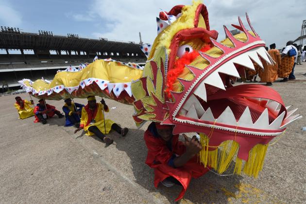 People perform with A Chinese dragon during a carnival . (PIUS UTOMI EKPEI / AFP)