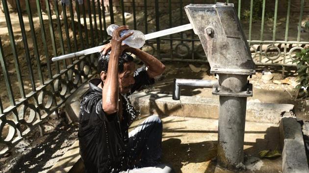 A man cools off on a roadside hand pump on a hot summer day in New Delhi on Monday. (Burhaan Kinu/HT PHOTO) A man cools off on a roadside hand pump on a hot summer day in New Delhi on Monday. (Burhaan Kinu/HT PHOTO)