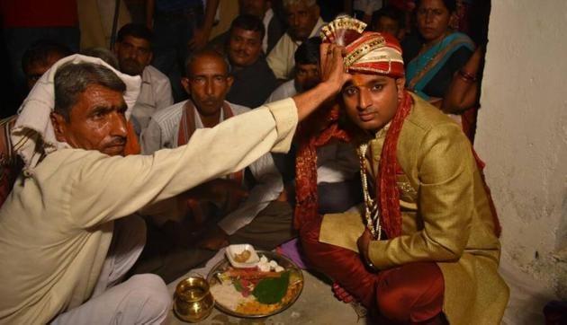 Ashok Yadav going through with the marriage rituals, moments before a revolver-wielding Bharti entered the scene.(HT Photo/ Handout)