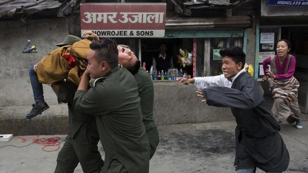 Exiled Tibetans enact a street play of abducting their religious leader Gedhun Choekyi Nyima, the 11th Panchen Lama by Chinese policemen. The abduction of Panchem Lama is considered by Tibetan Buddhists as part of China’s efforts to destabilise Tibet by introducing political propaganda, controlling its religion and limiting the Dalai Lama’s influence. (Ashwini Bhatia/AP)