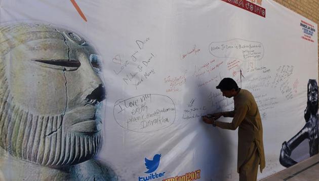A Pakistani visitor writes on a banner during an international conference near the UNESCO World Heritage archaeological site of Mohenjo-daro, some 425 kms north of Karachi city in Pakistan. (Asif Hassan/AFP) A Pakistani visitor writes on a banner during an international conference near the UNESCO World Heritage archaeological site of Mohenjo-daro, some 425 kms north of Karachi city in Pakistan. (Asif Hassan/AFP)