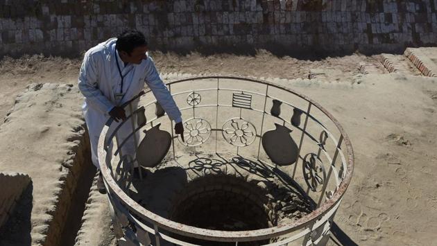 A caretaker at the archaeological site of Mohenjo-daro points out a well .The thermo stress as a result of the extreme hot weather coupled with salt from underground water is destroying the ruins. (Asif Hassan/AFP) A caretaker at the archaeological site of Mohenjo-daro points out a well .The thermo stress as a result of the extreme hot weather coupled with salt from underground water is destroying the ruins. (Asif Hassan/AFP)