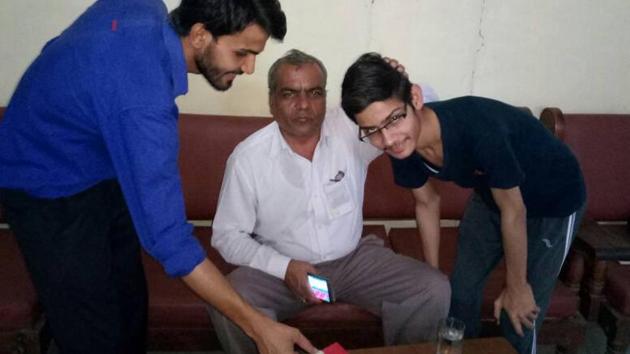 HBSE 2017 Class 12 topper Harish Sharma (left) with the director of his school, Vivekanand Senior Secondary, in Rewari. He secured 491 out of 500 marks and stood first in the entire state.(Handout)