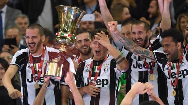 Juventus players celebrate with the trophy after winning the Coppa Italia final against Lazio.(AFP)