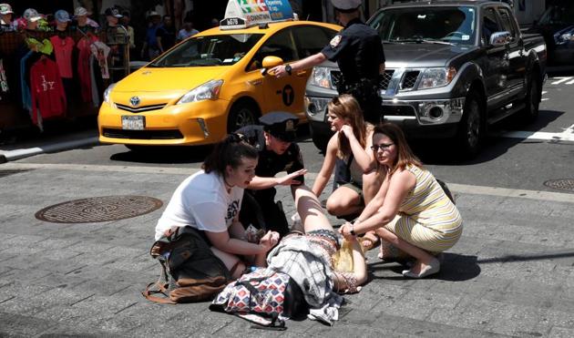 An injured woman is seen at a crosswalk in Times Square after a speeding vehicle struck pedestrians on the sidewalk in New York City. (REUTERS) An injured woman is seen at a crosswalk in Times Square after a speeding vehicle struck pedestrians on the sidewalk in New York City. (REUTERS)
