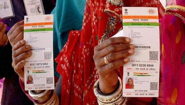 Rajasthani women showing their Aadhaar cards while standing in a queue to vote for Ajmer District Panchayat elections. (PTI) Rajasthani women showing their Aadhaar cards while standing in a queue to vote for Ajmer District Panchayat elections. (PTI)