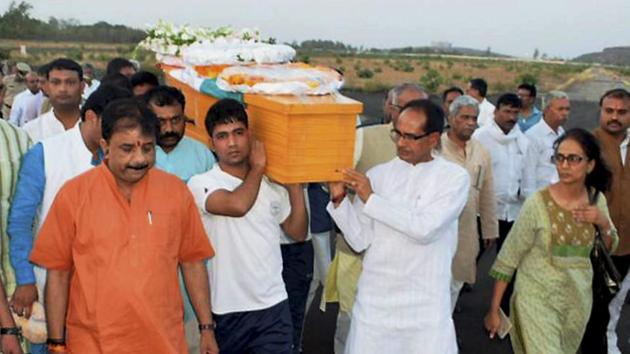 Madhya Pradesh chief minister Shivraj Singh Chouhan along with BJP leaders carrying the casket of Union minister Anil Madhav Dave at the airport in Bhopal on May 18. (PTI Photo)