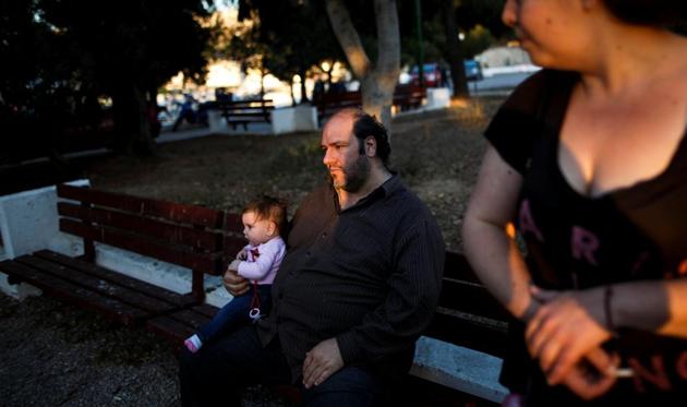 Kostas and Olga Argyros take their children to a local park in the Keratsini neighbourhood in Athens, Greece. Seven years into Greece’s economic crisis, those living on the fringes have been hit hard. According to ratings agency S&P, Greece has lost a third of its economic value since 2009. (Alkis Konstantinidis/REUTERS ) Kostas and Olga Argyros take their children to a local park in the Keratsini neighbourhood in Athens, Greece. Seven years into Greece’s economic crisis, those living on the fringes have been hit hard. According to ratings agency S&P, Greece has lost a third of its economic value since 2009. (Alkis Konstantinidis/REUTERS )