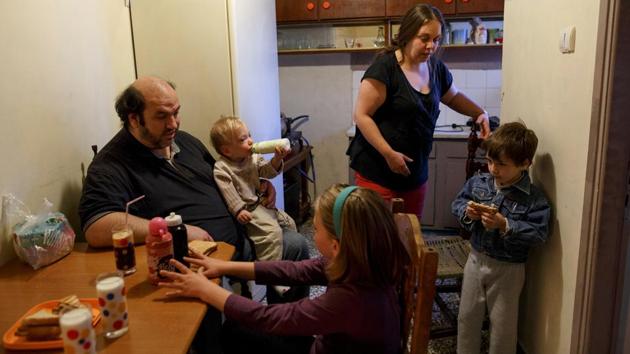The Argyros family have breakfast at their house in the Keratsini neighbourhood in Athens.They live in a small apartment with four children. (Alkis Konstantinidis/REUTERS ) The Argyros family have breakfast at their house in the Keratsini neighbourhood in Athens.They live in a small apartment with four children. (Alkis Konstantinidis/REUTERS )
