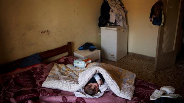 A baby rests in her parents bed at her house in Athens. Greece is on its way to its third international bailout since 2010. Struggling to contain a debt it is now in the brink of being disowned by the European Union. (Alkis Konstantinidis/REUTERS ) A baby rests in her parents bed at her house in Athens. Greece is on its way to its third international bailout since 2010. Struggling to contain a debt it is now in the brink of being disowned by the European Union. (Alkis Konstantinidis/REUTERS )