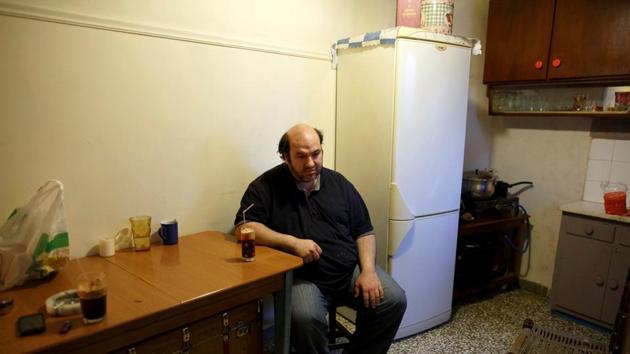 Kostas Argyros has his morning coffee at his home. He picks up occasional jobs here and there while his wife has been jobless for almost a decade now. (Alkis Konstantinidis/REUTERS ) Kostas Argyros has his morning coffee at his home. He picks up occasional jobs here and there while his wife has been jobless for almost a decade now. (Alkis Konstantinidis/REUTERS )