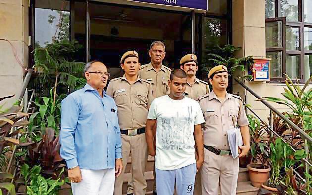 Anil Panwar in police custody . Anil Panwar in police custody .