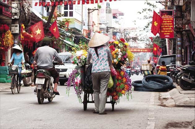 Wobbly bicycles laden with wares; fluid stream of overloaded bikes and chatty locals are a common sight in the Vietnamese capital.(Getty images)