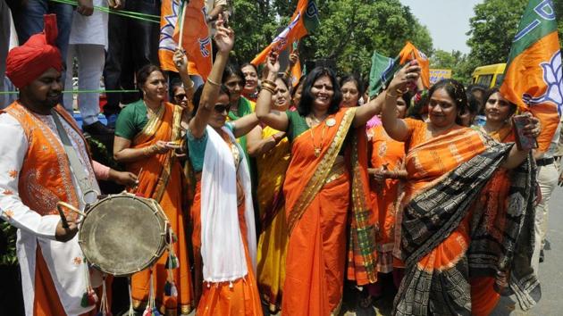 BJP chief Amit Shah greets his supporters during roadshow at sector 47, Chandigarh, on Saturday. (Karun Sharma/HT Photo)