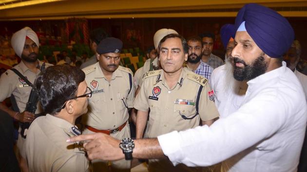 Former Akali minister and Majitha MLA Bikram Singh Majithia confronts ADGP Law & Order Rohit Chaudhary during a police public meeting in Majitha town on Saturday.(Sameer Sehgal/HT)