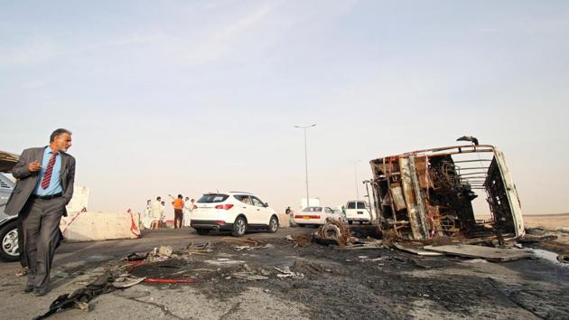 A man walks near the site of suicide car bomb attack on a highway near oilfields in southern Basra, Iraq, May 20, 2017. (REUTERS Photo) A man walks near the site of suicide car bomb attack on a highway near oilfields in southern Basra, Iraq, May 20, 2017. (REUTERS Photo)