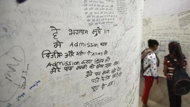 A wall in the Radha Krishna temple in Kota has prayers of students scribbled on them, in hopes that it will be answered. One recurring prayers is for an admission to the IIT, as seen in this photograph.(Raj K Raj/HT File Photo)