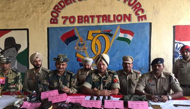 On interrogation, the BSF and police recovered four pistols (7.62mm) with nine magazines, one 9mm pistol with two magazines, an AK-47 assault rifle with three magazines, a modified rifle with two magazines, five hand grenades and over 450 rounds of ammunition of different calibre buried close to the Indo-Pak border. (HT Photo) On interrogation, the BSF and police recovered four pistols (7.62mm) with nine magazines, one 9mm pistol with two magazines, an AK-47 assault rifle with three magazines, a modified rifle with two magazines, five hand grenades and over 450 rounds of ammunition of different calibre buried close to the Indo-Pak border. (HT Photo)