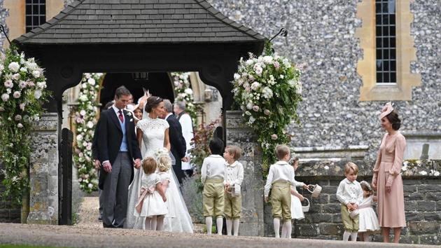 Pippa wore a lace-encrusted creation from British designer Giles Deacon, who said in a statement issued by Middleton’s publicist, Jo Milloy, that he was “thrilled” to work with Pippa on her wedding dress. (Justin TALLIS / AFP) 