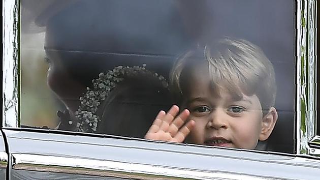 Britain's Prince George waves as he leaves in a car after attending the wedding. (Justin TALLIS / AFP) 