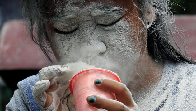 A girl's face is covered by a white powder after blowing on it, while participating in a game during a religious festival honouring patron saint Santa Rita de Cascia in Paranaque city, metro Manila, Philippines. (Romeo Ranoco / REUTERS)
